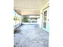 Covered outdoor patio with views to the green backyard and trees at 5860 Sw 64Th Street Rd, Ocala, FL 34474
