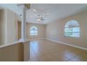 Bright living room with tile flooring, ceiling fan, and lots of natural light at 5916 Nw 27Th Pl, Ocala, FL 34482