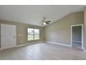 Bright living room with tile floors, vaulted ceilings, and lots of natural light at 6047 Sw 128Th Street Rd, Ocala, FL 34473