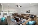 Spacious living room features wood floors, modern fan, and plush seating for Gathering relaxation at 6125 Se 11Th St, Ocala, FL 34472