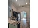 Kitchen with stainless steel appliances, granite countertops, and a view into the dining room at 7677 Sw 81St Pl, Ocala, FL 34476