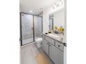 Modern bathroom with a glass-enclosed shower and elegant vanity with granite countertop at 10069 Sw 140Th Ave, Dunnellon, FL 34432