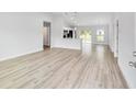 Bright living room featuring new vinyl floors and a kitchen with a breakfast bar at 13395 Sw 106 St, Dunnellon, FL 34432