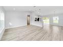 Bright living room featuring new vinyl floors and a kitchen with a breakfast bar at 13395 Sw 106 St, Dunnellon, FL 34432