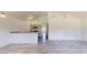 Open-concept living room with wood-style flooring, vaulted ceiling, and modern finishes at 13627 Sw 103Rd Pl, Dunnellon, FL 34432
