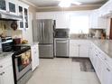 Bright kitchen featuring stainless steel appliances, white cabinets, and granite countertops at 13686 Sw 111Th Ave, Dunnellon, FL 34432