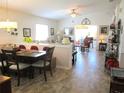 Open-concept living and dining area with neutral decor and lots of natural light at 13686 Sw 111Th Ave, Dunnellon, FL 34432