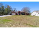 Charming single-story home with a stucco exterior, arched entry, and well-maintained lawn on a sunny day at 16272 Se 89Th Ct, Summerfield, FL 34491