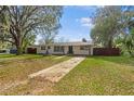Classic single-story home with a spacious front yard, mature tree, and long driveway at 1818 Se Lake Weir Ave, Ocala, FL 34471