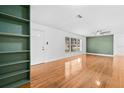 Bright living room featuring hardwood floors, ample natural light, and built-in bookshelves at 1818 Se Lake Weir Ave, Ocala, FL 34471