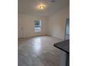 Bright living room featuring tile floors and ample natural light, creating a welcoming space at 261 Locust Pass Loop, Ocala, FL 34472