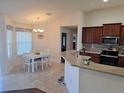 Bright kitchen with granite countertops, stainless steel appliances, and a cozy eat-in area at 3819 Se 99Th St, Belleview, FL 34420