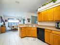 Functional kitchen featuring wooden cabinets and black appliances at 4941 Nw 32 Street, Ocala, FL 34482
