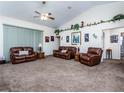 Spacious living room with plush leather furniture and vaulted ceilings at 4941 Nw 32 Street, Ocala, FL 34482