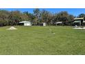 Expansive backyard featuring outbuildings and ample green space at 5124 Cr 634S, Bushnell, FL 33513