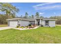 Lovely one-story home showcasing a well-kept lawn and a front yard adorned with beautiful landscaping at 5620 Sw 172Nd Loop, Ocala, FL 34473