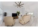 Large living room featuring tile floors, a ceiling fan, and comfortable seating at 8330 Se 161St St, Summerfield, FL 34491