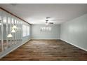 An open concept living room featuring wood floors, updated walls, with ceiling fan and plenty of light at 9025 Sw 94Th Ln # C, Ocala, FL 34481