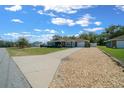 Well-maintained home with a long driveway, landscaping, and an inviting front entrance at 9436 Se 163Rd St, Summerfield, FL 34491