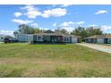 Charming single-story home with a well-manicured lawn, cute bushes, and an inviting front entrance at 9436 Se 163Rd St, Summerfield, FL 34491