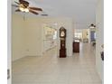 View from tiled foyer into kitchen with white appliances and living space at 9575 Sw 92Nd Street Rd, Ocala, FL 34481