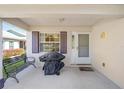 Warm, neutral, covered front porch with mature landscaping and seating at 9575 Sw 92Nd Street Rd, Ocala, FL 34481
