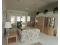 Inviting living room with vaulted ceiling, neutral carpet, and bright natural light from the sliding glass door at 9610 Sw 198Th Cir, Dunnellon, FL 34432