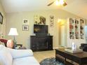 A cozy living room with a fireplace, ceiling fan, and ample seating at 11792 Sw 137Th Loop, Dunnellon, FL 34432