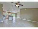 Open-concept living space features a modern kitchen with stainless steel appliances at 12805 Sw 38Th Cir, Ocala, FL 34473