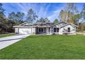 Beautiful one-story home with a well-manicured lawn and a two-car garage at 13180 Sw 80Th St, Dunnellon, FL 34432
