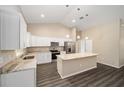 Modern kitchen featuring white cabinets, an island, and stainless steel appliances at 13180 Sw 80Th St, Dunnellon, FL 34432