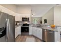 Modern kitchen featuring stainless steel appliances, white cabinets, and granite countertops at 15428 Sw 60Th Cir, Ocala, FL 34473