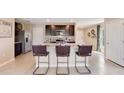 Modern kitchen featuring an island with barstool seating, dark cabinetry, and stainless steel appliances at 2170 Ne 28Th Ln, Ocala, FL 34470