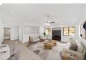 Bright living room with vaulted ceilings, neutral paint, and modern furnishings showcasing a cozy space at 3616 Ne 17Th Ln, Ocala, FL 34470