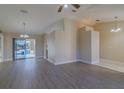 Open-concept living area with luxury vinyl plank flooring and sliding doors leading to an outdoor pool at 5115 Nw 21St Loop, Ocala, FL 34482