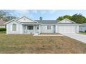 Welcoming single-story home with a neat front yard and attached garage at 5347 Nw 20Th Pl, Ocala, FL 34482