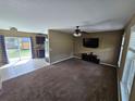 Cozy living room with carpet flooring and a view of the backyard at 5520 Nw 57Th St, Ocala, FL 34482