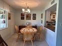 Cozy dining area with a chandelier, adjacent to a view of the kitchen and built-in bookcase at 566 Fairways Cir # B, Ocala, FL 34472