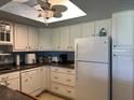 Bright kitchen featuring white cabinets, modern appliances and plenty of storage space at 566 Fairways Cir # B, Ocala, FL 34472