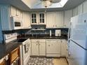 Bright kitchen featuring white cabinets, modern appliances and plenty of storage space at 566 Fairways Cir # B, Ocala, FL 34472