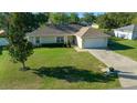 Beautiful home featuring manicured lawn and a two-car garage in a serene setting at 7 Fir Drive Trce, Ocala, FL 34472