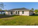 Spacious backyard with sliding glass doors and a well-maintained lawn at 75 Pine Crse, Ocala, FL 34472