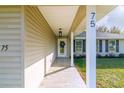 Inviting entryway featuring stylish tile flooring and modern light fixture at 75 Pine Crse, Ocala, FL 34472