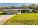 Beautiful single-story home featuring a manicured lawn and an attached garage at 75 Pine Crse, Ocala, FL 34472