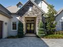 Elegant front entryway with stone accents and a stylish, modern double-door entrance at 7635 Nw 33Rd Pl, Ocala, FL 34482