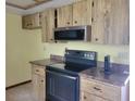 Functional kitchen featuring ample wood cabinetry, sleek countertops, and updated stainless steel appliances, ready for culinary adventures at 8344 Sw 107Th Pl, Ocala, FL 34481