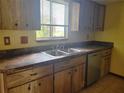 Well-equipped kitchen with plenty of wood cabinets, countertop space, stainless steel sink and a dishwasher at 8344 Sw 107Th Pl, Ocala, FL 34481