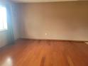 Bright living room featuring gleaming hardwood floors, neutral wall paint, and a large window for natural light at 8344 Sw 107Th Pl, Ocala, FL 34481