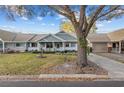 Inviting home with a cozy porch and attached garage, set on a green lawn with mature trees at 8533 Sw 93Rd Pl # C, Ocala, FL 34481