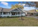 Quaint home with a charming porch, complemented by lush green lawn and shade trees at 8533 Sw 93Rd Pl # C, Ocala, FL 34481